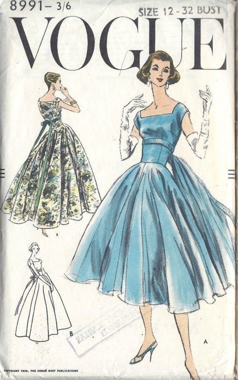 May include: Vintage Vogue sewing pattern featuring illustrations of elegant dresses. The cover displays a blue dress with a square neckline and a full skirt, alongside a floral print dress and a line drawing. The text "VOGUE" is prominently displayed.