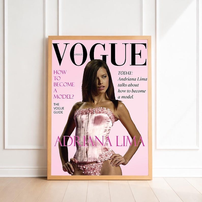 May include: A framed Vogue magazine cover featuring Adriana Lima. The cover is pink with the Vogue logo at the top. Text includes "How to Become a Model?" and "Adriana Lima". The model is wearing a pink corset.
