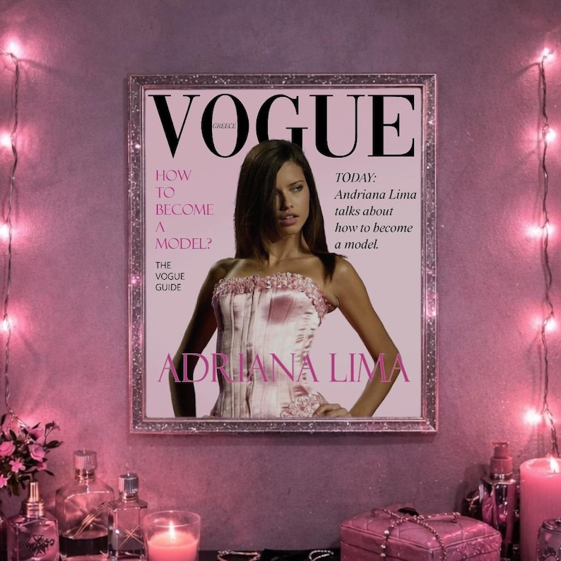 May include: A framed Vogue magazine cover featuring Adriana Lima. The cover is predominantly pink, with the Vogue logo at the top and the text "How to Become a Model?" and "Adriana Lima" prominently displayed. The image is surrounded by decorative lights.