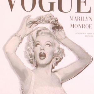 May include: Vogue magazine cover featuring Marilyn Monroe. The cover has a sepia tone with the word "VOGUE" at the top. Monroe is wearing a crown and jewelry. The text "MARILYN MONROE" is below the Vogue logo. The text "August, 63 hollywood" is at the bottom.