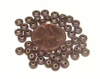 5x3mm Antique Copper Tibetan style spacers. Bicone shaped with 1.5mm hole. (100)