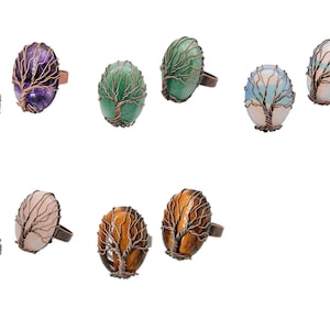 May include: Assortment of oval-shaped rings with a copper wire tree design. The stones are amethyst, green aventurine, blue lace agate, rose quartz, and tiger's eye.