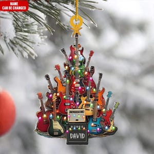 May include: A guitar-themed Christmas tree ornament. The ornament is shaped like a Christmas tree and is composed of various colorful guitars. The base features an amplifier with the name "DAVID" on it. The ornament is decorated with string lights.