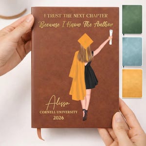 May include: Brown leather-bound journal with gold lettering that reads "I Trust The Next Chapter Because I Know The Author." Features a graduation illustration and the name "Alissa" with "Cornell University 2026".