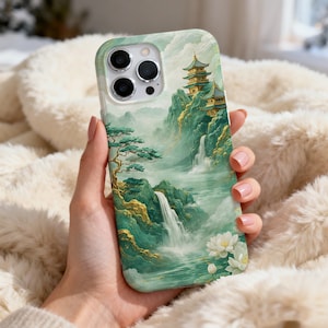 May include: A phone case featuring a serene landscape with a waterfall, pagoda, and lush greenery. The design incorporates shades of green, gold, and white, creating a tranquil aesthetic. The case is designed to fit a smartphone.