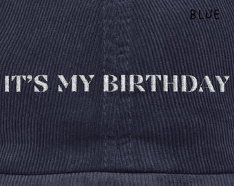 May include: Navy blue corduroy baseball cap with the embroidered text "IT'S MY BIRTHDAY". The cap also has the words "NAVY BLUE" embroidered on the side. A stylish accessory for a birthday celebration.