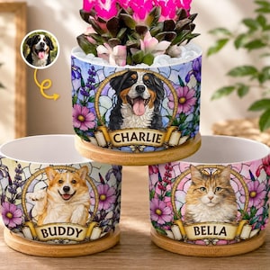 May include: Three cylindrical ceramic planters on bamboo saucers, each featuring a stained-glass style floral pattern and a central portrait of a pet. The planters display the names Charlie, Buddy, and Bella on gold-toned banners below the pets.