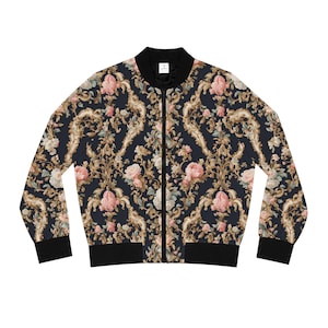 May include: A black bomber jacket with a floral pattern featuring pink roses and gold accents. The jacket has a zipper closure and ribbed cuffs and waistband.