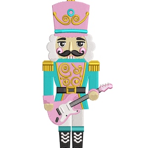May include: An embroidered nutcracker figure wearing a pink hat with gold accents, a teal jacket with gold scrollwork, and black boots. The nutcracker has white hair, a black mustache, and is holding a pink electric guitar with a white pickguard.