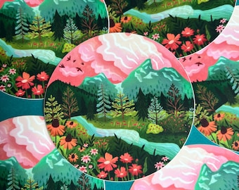 May include: Circular art prints featuring a landscape scene with mountains, a river, and colorful flowers. The artwork has a pink and green color palette, with a stylized depiction of nature. Several prints are arranged together on a teal background.