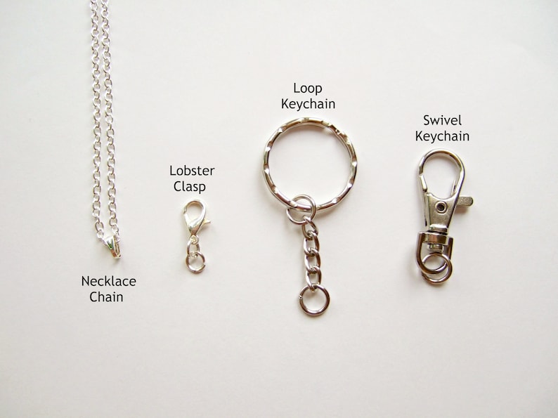 May include: A silver necklace chain with a lobster clasp, a loop keychain with a silver chain, and a swivel keychain.