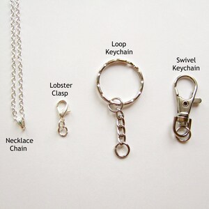 May include: Three different types of metal chains: a necklace chain with a lobster clasp, a loop keychain, and a swivel keychain.