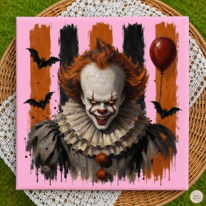 May include: A square canvas print featuring a clown with orange hair, white face paint, and a ruffled collar. The background has vertical black and orange stripes with three black bats and a single red balloon floating on the right side.