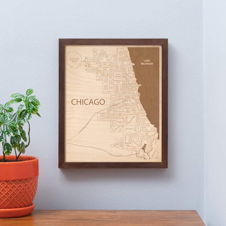 a picture of chicago on a wall next to a potted plant