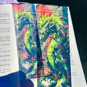 Punk Dragon Bookmark – Neon Green Gritty Dragon Wrapped in Chains Reading a Romance Novel, Bold Dark Fantasy Art Bookmark