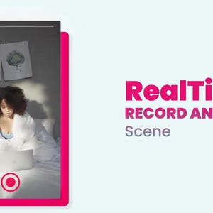 May include: A person in a white robe sits on a bed with a laptop. The image includes the text "RealTime RECORD ANIMATION Scene" in pink. Two framed botanical prints hang on the wall behind them.