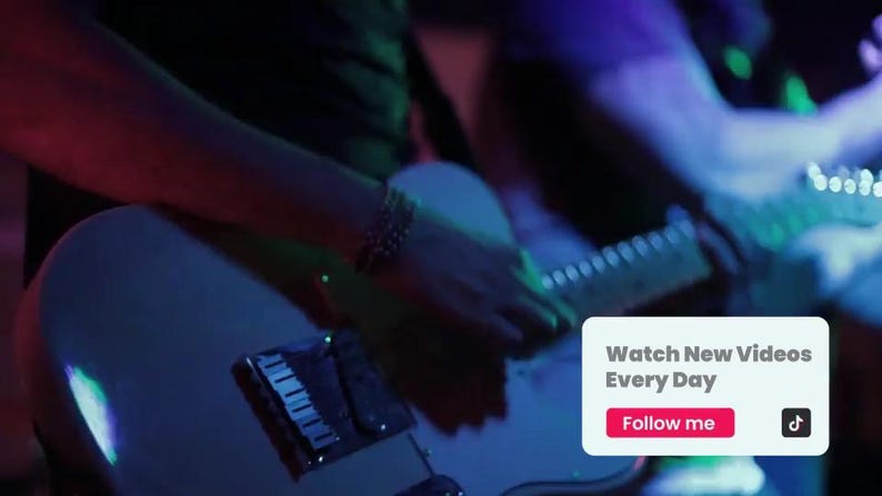 May include: A white electric guitar is held by a person, with the neck and strings visible. The image is bathed in blue and red stage lighting. A small white box with the text "Watch New Videos Every Day" and "Follow me" is in the lower right corner.