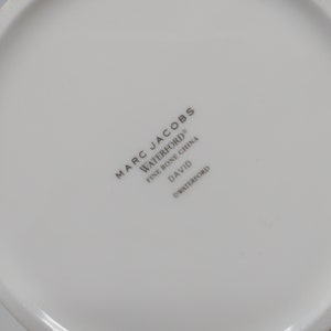 May include: White ceramic plate with the text "MARC JACOBS WATERFORD&reg; FINE BONE CHINA DAVID &copy;WATERFORD" printed on the bottom.