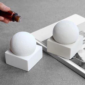 May include: A rustic wooden sign with the text "Welcome to our home" in white lettering. The sign features a distressed finish and a simple, inviting design, perfect for front door decor.