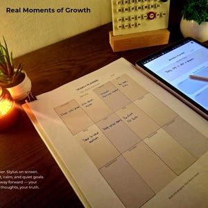 Lifestyle photo of digital planner on tablet (Samsung Notes/GoodNotes) and printed yearly planner. Styled with candlelight and desk plants. Perfect for cozy journaling, vision board set, goal roadmap, and productivity tools.