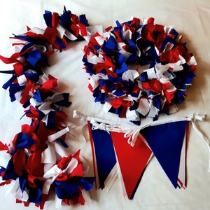 May include: A patriotic collection of red, white, and blue fabric decorations. The image features a wreath, garland, and bunting. The wreath and garland are made of fabric strips. The bunting has red and blue triangular flags.