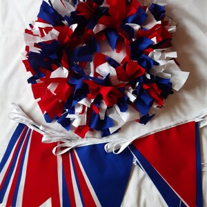 May include: A festive wreath and bunting set in red, white, and blue. The wreath is made of fabric strips, and the bunting features triangular flags. Perfect for patriotic or celebratory decor.