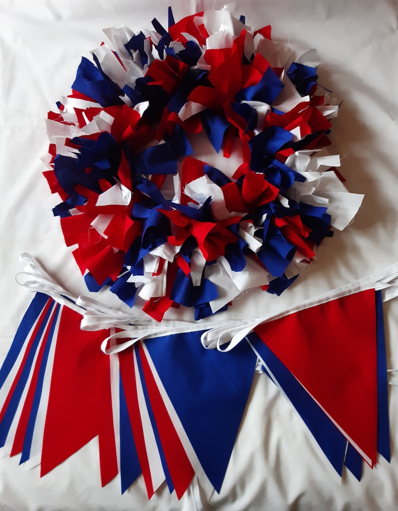 May include: A festive wreath and bunting set in red, white, and blue. The wreath is made of fabric strips, and the bunting features triangular flags. Perfect for patriotic or celebratory decor.