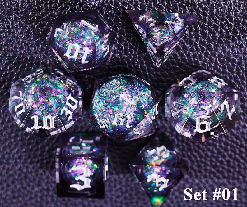 May include: A set of seven polyhedral dice with a dark purple, glittery interior and white numbering. The dice are in various geometric shapes, including a d4, d6, d8, d10, d12, d20, and a percentile die. The text "Set #01" is in the bottom right corner.
