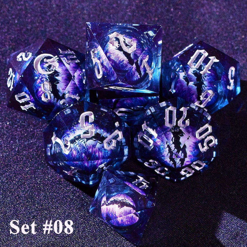 May include: A set of seven multi-sided dice with a galaxy-like design in shades of purple and blue. The dice have silver numbering and a detailed interior design. The text "Set #08" is visible.