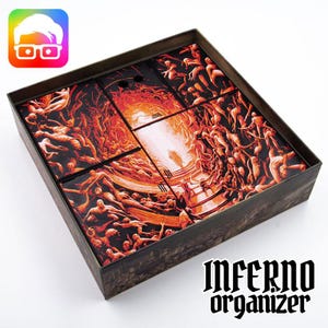 May include: A square box with a dark, detailed illustration of a hellscape, featuring figures and flames. The box contains several smaller, puzzle-like pieces with the same artwork. The text "INFERNO organizer" is printed on the box.