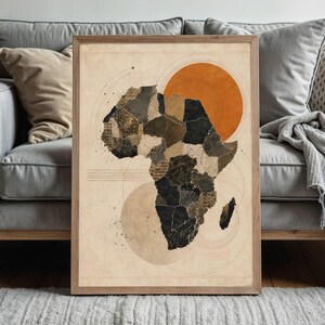 May include: A framed wall art print featuring a stylised map of Africa composed of various textured, dark-toned segments. The map is set against a light beige background with a large orange circle, thin circular line patterns, and horizontal lines.