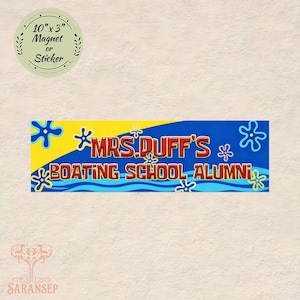 May include: A rectangular magnet or sticker with the text "MRS. DUFF'S BOATING SCHOOL ALUMNI" in red and yellow on a blue background. The magnet is 10 inches by 3 inches and features a floral design.