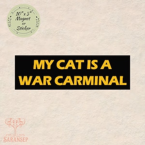 May include: A black rectangle magnet or sticker with the text "MY CAT IS A WAR CARMINAL" in yellow. A circular sticker in the upper left corner reads "10" x 3" Magnet or Sticker".
