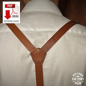 May include: Brown leather suspenders with a Y-back design, attached to a white shirt. The suspenders feature a decorative stitched detail at the back. The image includes a PDF download icon in the upper left corner. The suspenders are a classic accessory.