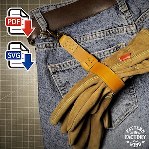 May include: A pair of work gloves secured with a tan leather strap and metal clasp, attached to blue denim jeans. The strap features decorative stitching and perforations. A PDF and SVG icon are in the upper left corner.