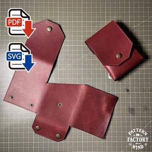 May include: A dark red leather pouch pattern shown in both an unfolded flat state and a folded assembled state, featuring metallic snap fasteners. The image includes PDF and SVG file icons and the text Pattern Factory Wind in the corner.