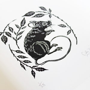 May include: Black and white linocut print of a mouse sitting on a branch with leaves. The print is signed "Cally '16" and numbered "1/23".