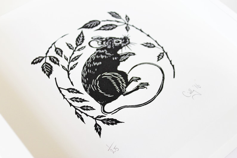 May include: Black and white linocut print of a mouse sitting on a branch with leaves. The print is signed "Cally '16" and numbered "1/23".