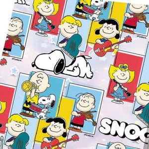 May include: Wrapping paper featuring a repeating pattern of Peanuts characters playing musical instruments, including Snoopy, Charlie Brown, Lucy, and Schroeder. The design includes colourful rectangular frames, small stars, and the text SNOOPY.
