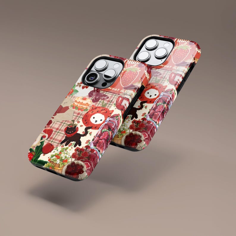 May include: Two phone cases with a whimsical strawberry design. The cases feature a collage of strawberries, cakes, and a cartoon cat. The cases have a glossy finish and are set against a neutral background.