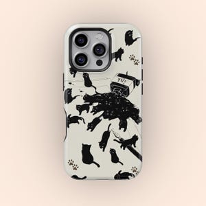 May include: A phone case with a cream-coloured background, decorated with black cat silhouettes and paw prints. The design includes a spilled ink bottle labelled "Ink", with the ink forming a cat-shaped puddle.