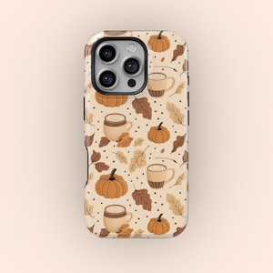 May include: A phone case with a seasonal autumn design. The pattern includes pumpkins, coffee cups, and leaves in orange, brown, and beige tones. The case has a shiny surface and a camera aperture.