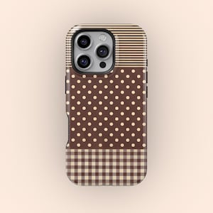 Op de afbeelding: Een telefoonhoesje met bruine en beige patronen. De hoes heeft een stippenpatroon, horizontale strepen en een ruitpatroon. Het is ontworpen voor een smartphone en heeft een uitsparing voor de camera.