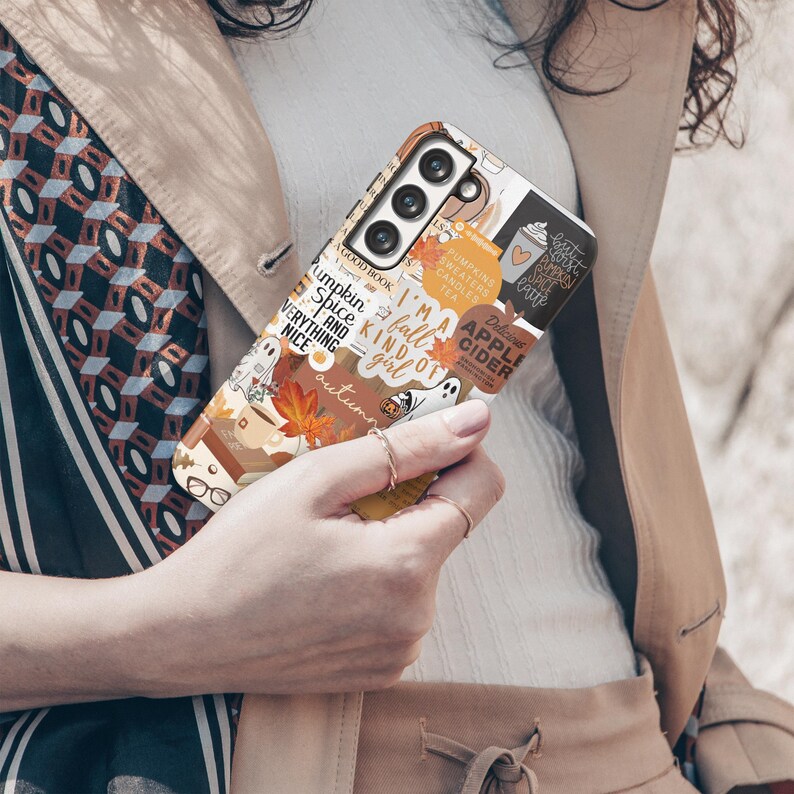 May include: A phone case with a fall-themed design featuring a pumpkin, leaves, and the text "I'm a fall kind of girl". The case is white with a colorful design.