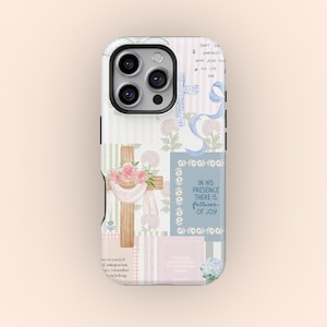 May include: A phone case with a patchwork design featuring crosses, floral accents, and inspirational text. The case has a mix of pastel colors, including pink, blue, and green. The text includes phrases like "In His Presence There is Fullness of Joy."