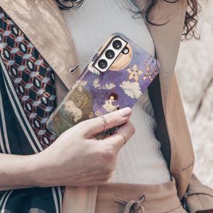May include: A phone case with a whimsical illustration featuring a girl, moon, stars, and clouds in shades of purple, blue, and yellow. The case has a glossy finish and a camera cutout.