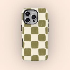 May include: A phone case featuring a cream and olive green chequerboard pattern. The case has a black border and a camera cutout. The design shows a grid of olive green squares on a cream background.