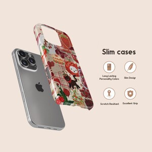 May include: A silver smartphone with a decorative phone case featuring a colorful pattern of strawberries, cartoon characters, and plaid. The text "Slim cases" is displayed.