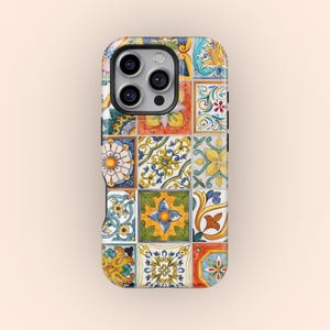 May include: A phone case with a vibrant mosaic tile pattern. The case is rectangular with rounded edges and a camera aperture. The tile design incorporates floral and geometric motifs in blue, yellow, orange, and green hues.