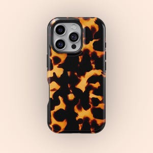 May include: A phone case with a tortoiseshell pattern. The case has a black border and a repeating pattern of dark brown and orange shapes. The case is designed to fit a smartphone with multiple camera lenses.